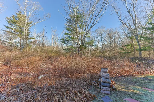 a backyard of a house with table and chairs