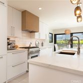 a kitchen with stainless steel appliances granite countertop a sink a stove and a refrigerator
