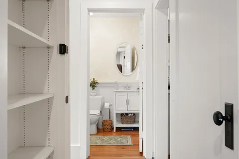 a en suite bathroom with a granite countertop sink and a mirror