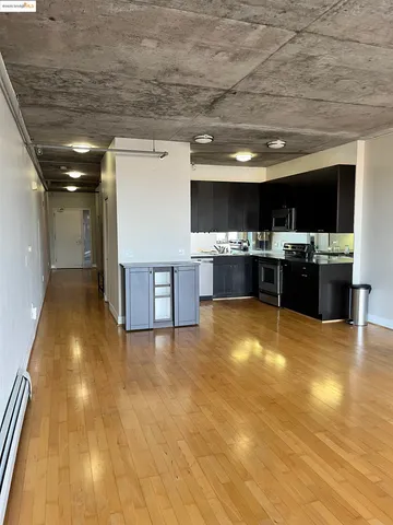 a view of kitchen appliances and wooden floor