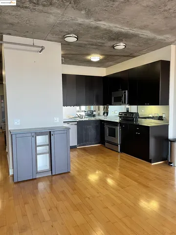 a view of a kitchen with a sink and cabinets