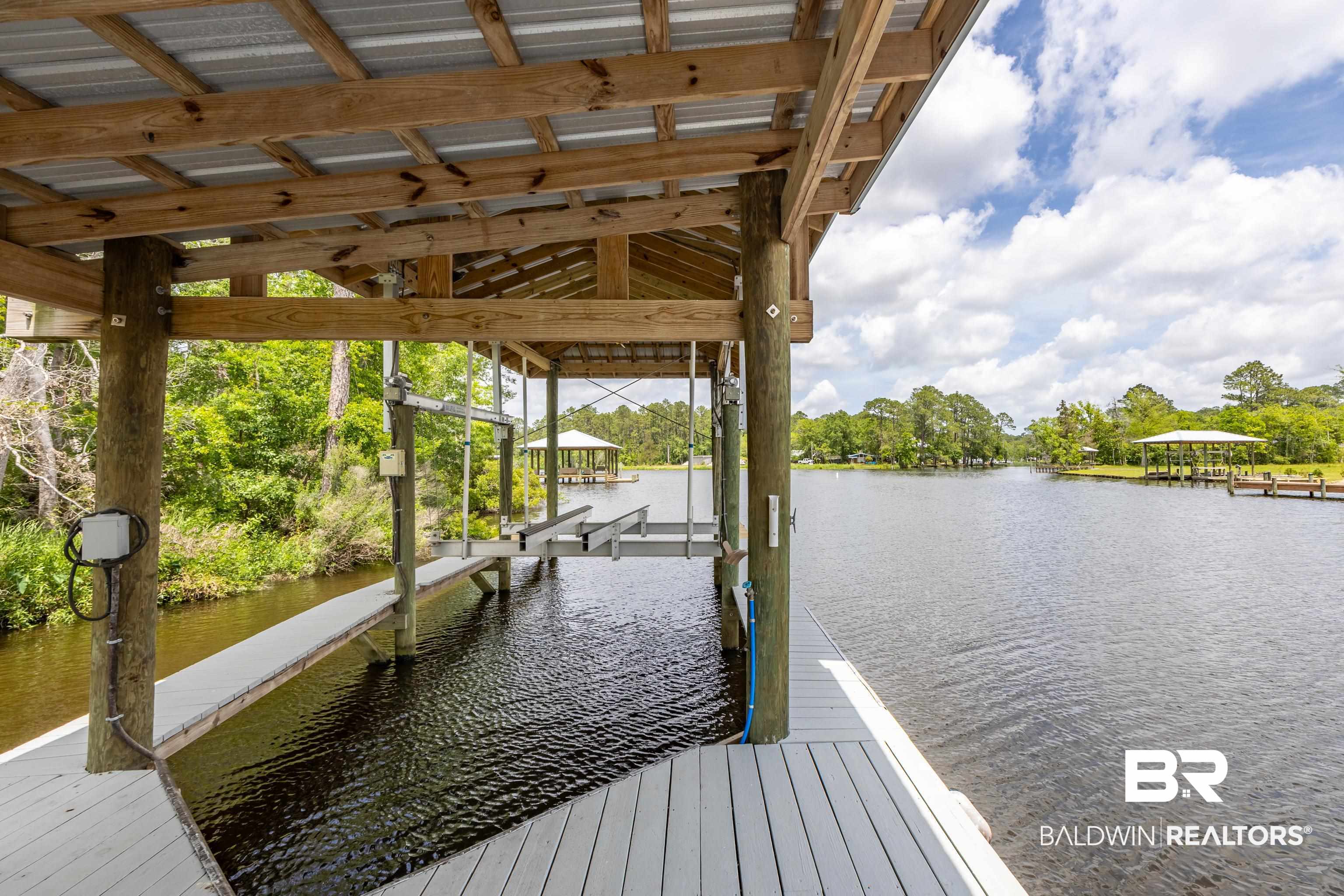 9771 Clarke Ridge Road Foley, AL 36535 - Photo 17 of 72 The dock area features a water view and a boat lift.