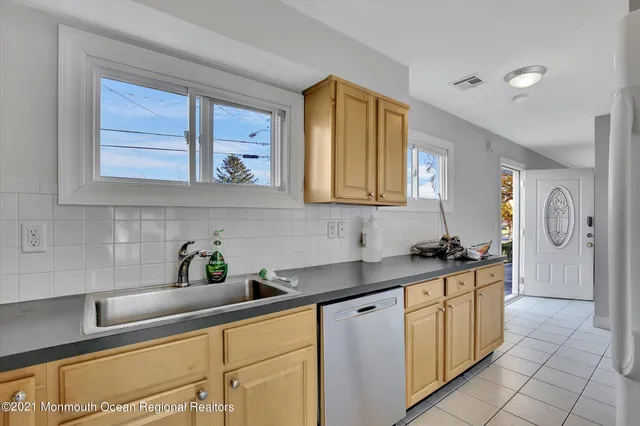 a kitchen with stainless steel appliances granite countertop a sink a stove and a microwave