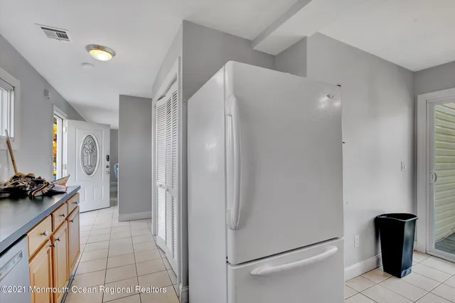 a kitchen with a refrigerator and a stove