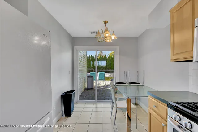 a dining room with furniture and a window
