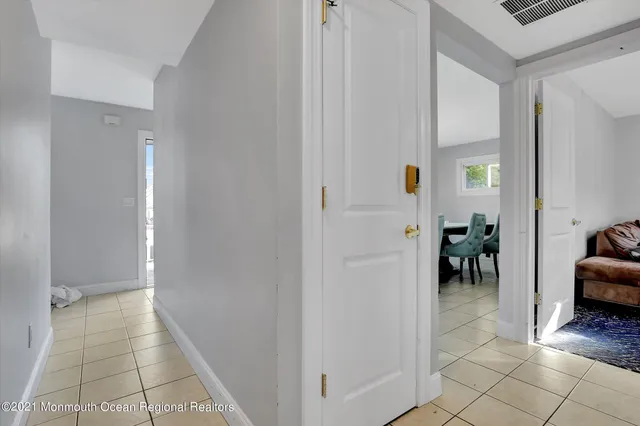 a view of a hallway with living room and dining room