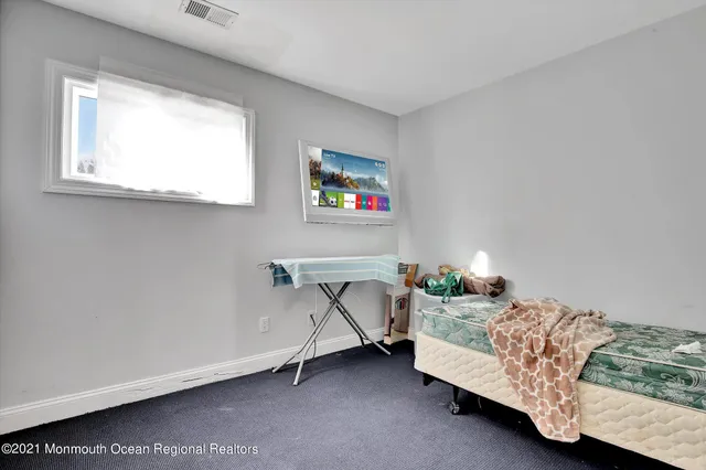 a bedroom with furniture and a window