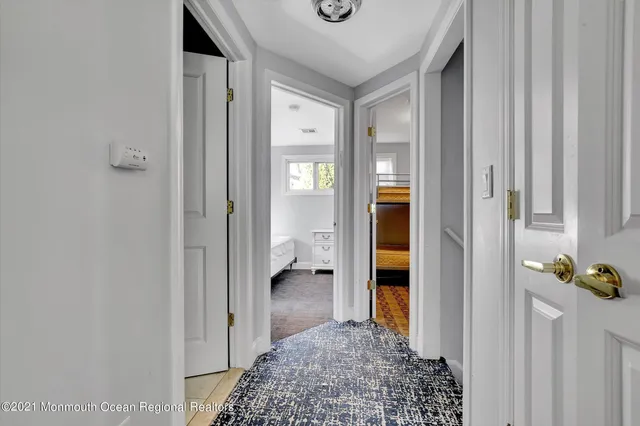 a view of hallway with wooden floor