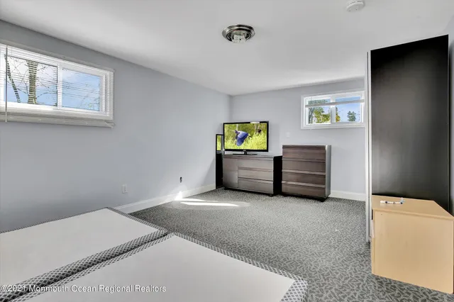 a living room with furniture and a lamp