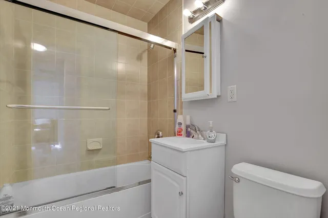 a bathroom with a sink mirror vanity and toilet