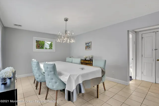 a view of a dining room with furniture and chandelier