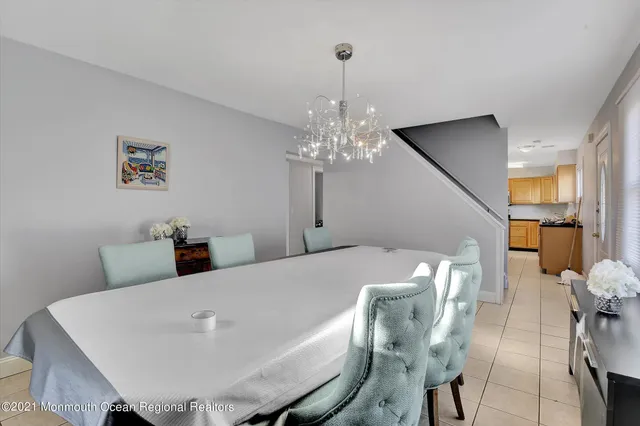 a view of a dining room with furniture and chandelier