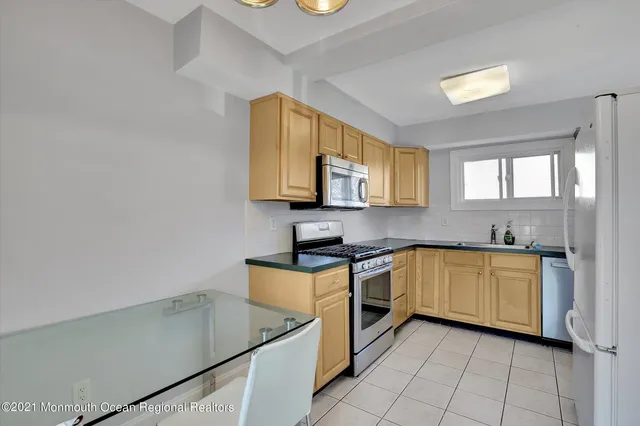 a kitchen with stainless steel appliances granite countertop a sink and a stove
