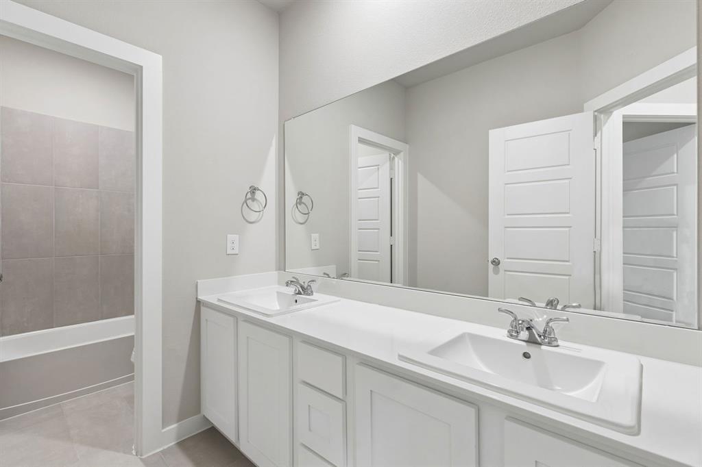 1121 Del Rio Drive Lavon, TX 75166 - Photo 25 of 32 a bathroom with a sink and a mirror