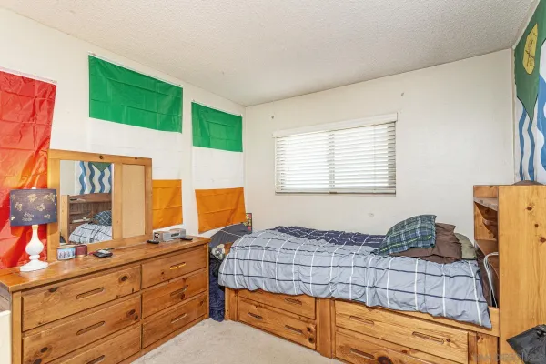 a bedroom with a bed and a dresser