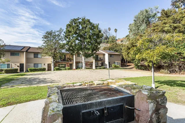 a view of a house with backyard and sitting area
