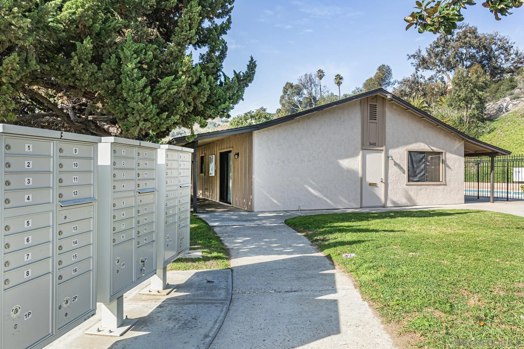 3433 Fairlomas Road National City, CA 91950 - Photo 39 of 43 a white house with a small yard plants and large tree