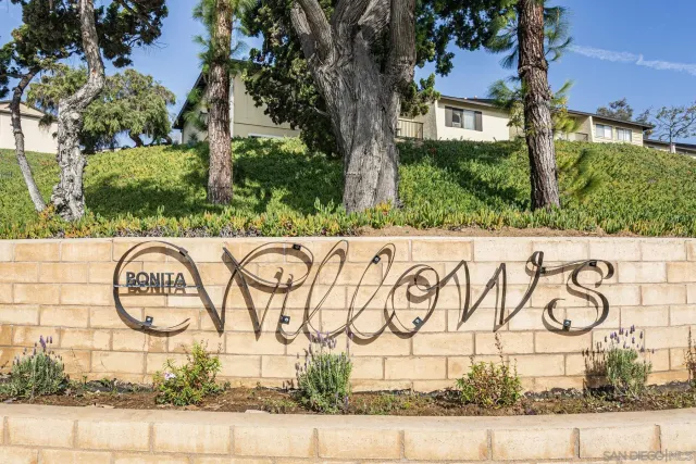 a street sign on a wall next to a road
