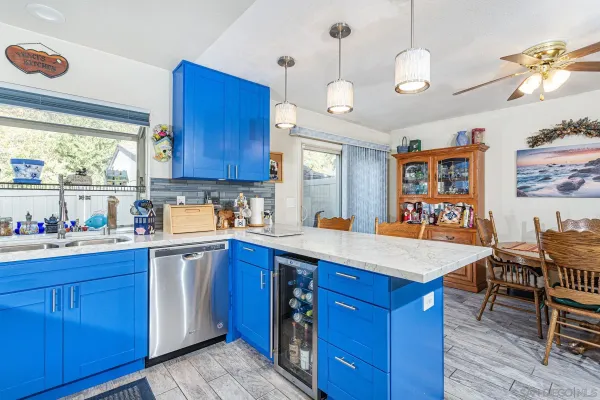 a kitchen with stainless steel appliances granite countertop a sink dishwasher stove and wooden cabinets