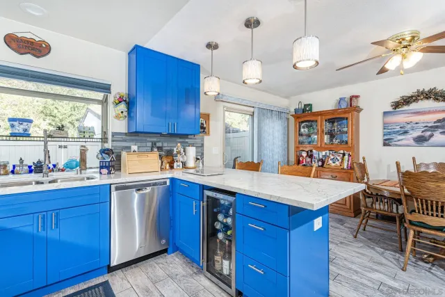 a kitchen with stainless steel appliances granite countertop a sink dishwasher stove and wooden cabinets