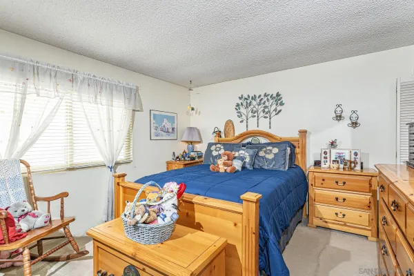 a bedroom with a bed and a dresser in it