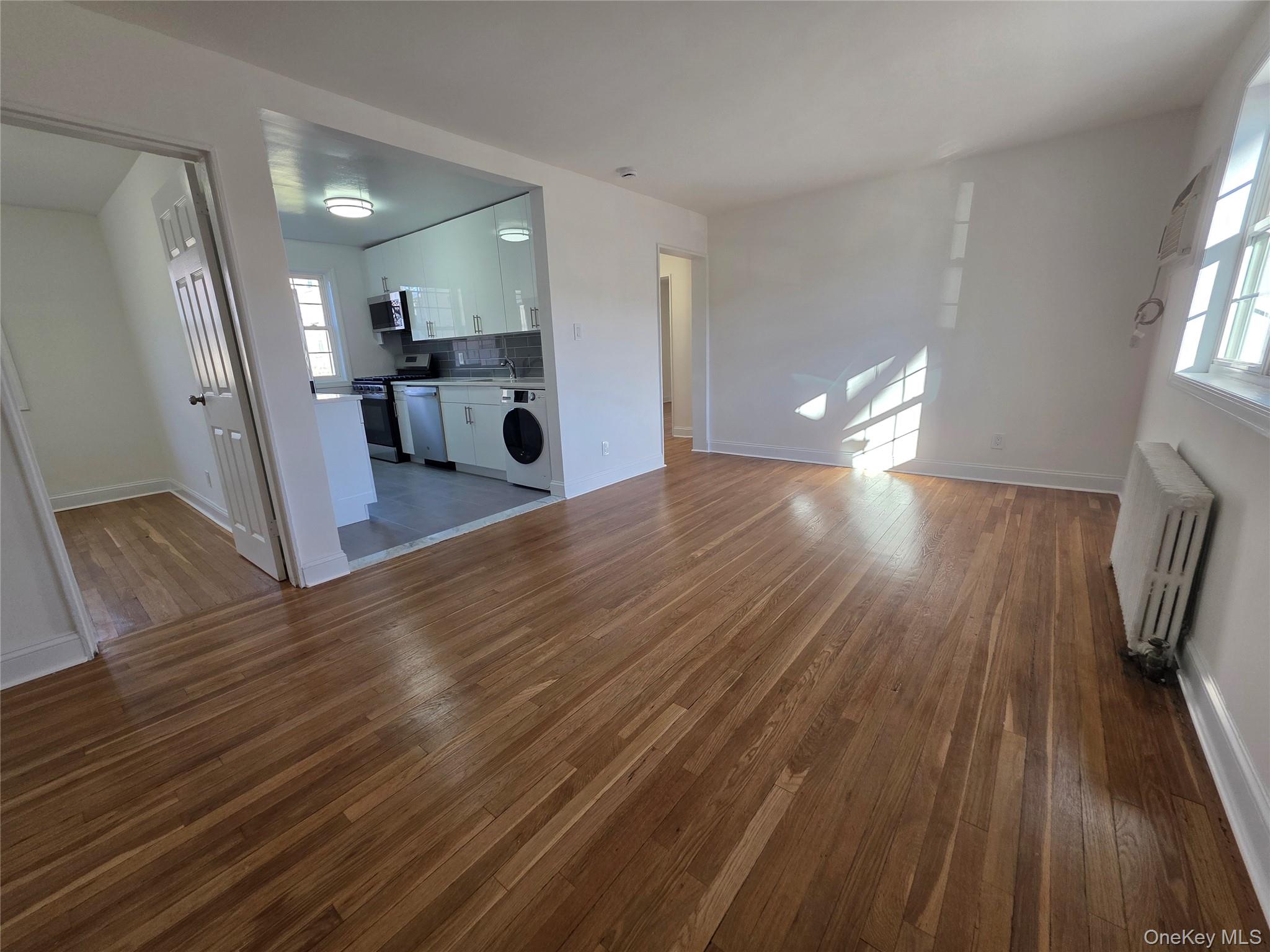 a view of a electric room and wooden floor