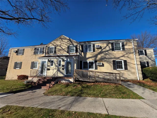 a view of a street with cars parked