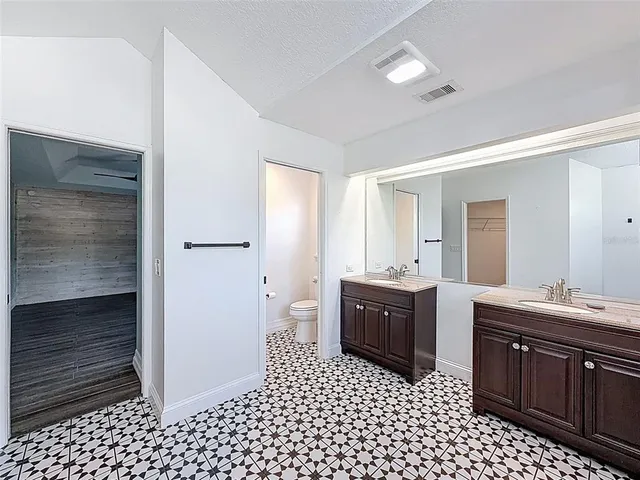 a kitchen with stainless steel appliances granite countertop a sink a stove and cabinets