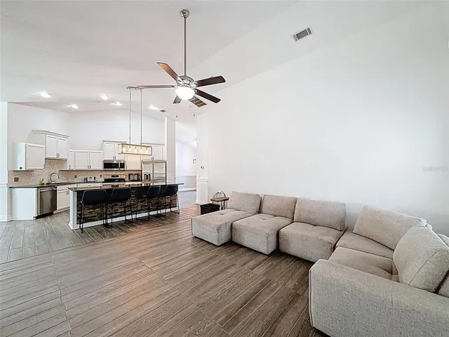 a view of a dining room with furniture and wooden floor