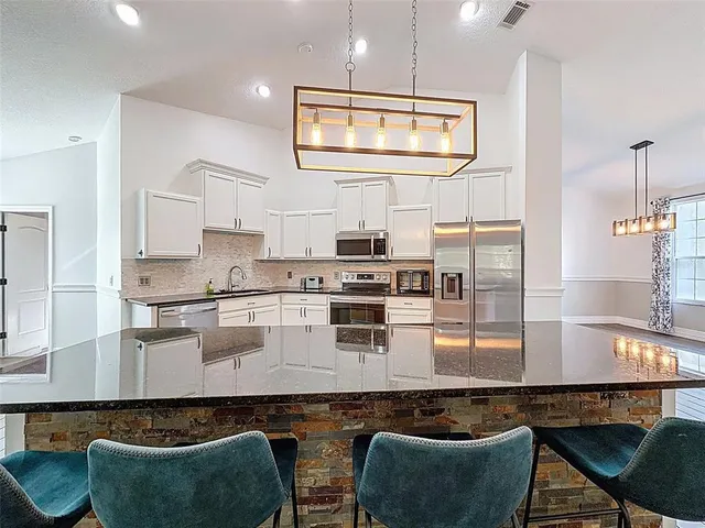 a bedroom with a bed and a view of kitchen