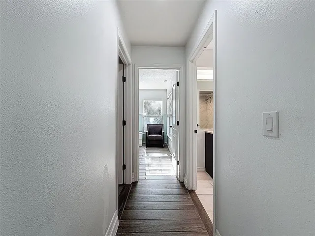an aerial view of residential houses with outdoor space and trees