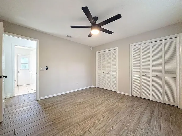 an aerial view of residential houses with outdoor space and trees