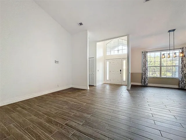 a view of a hallway with wooden floor and closet area