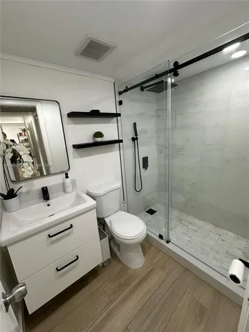 a bathroom with a sink toilet and shower