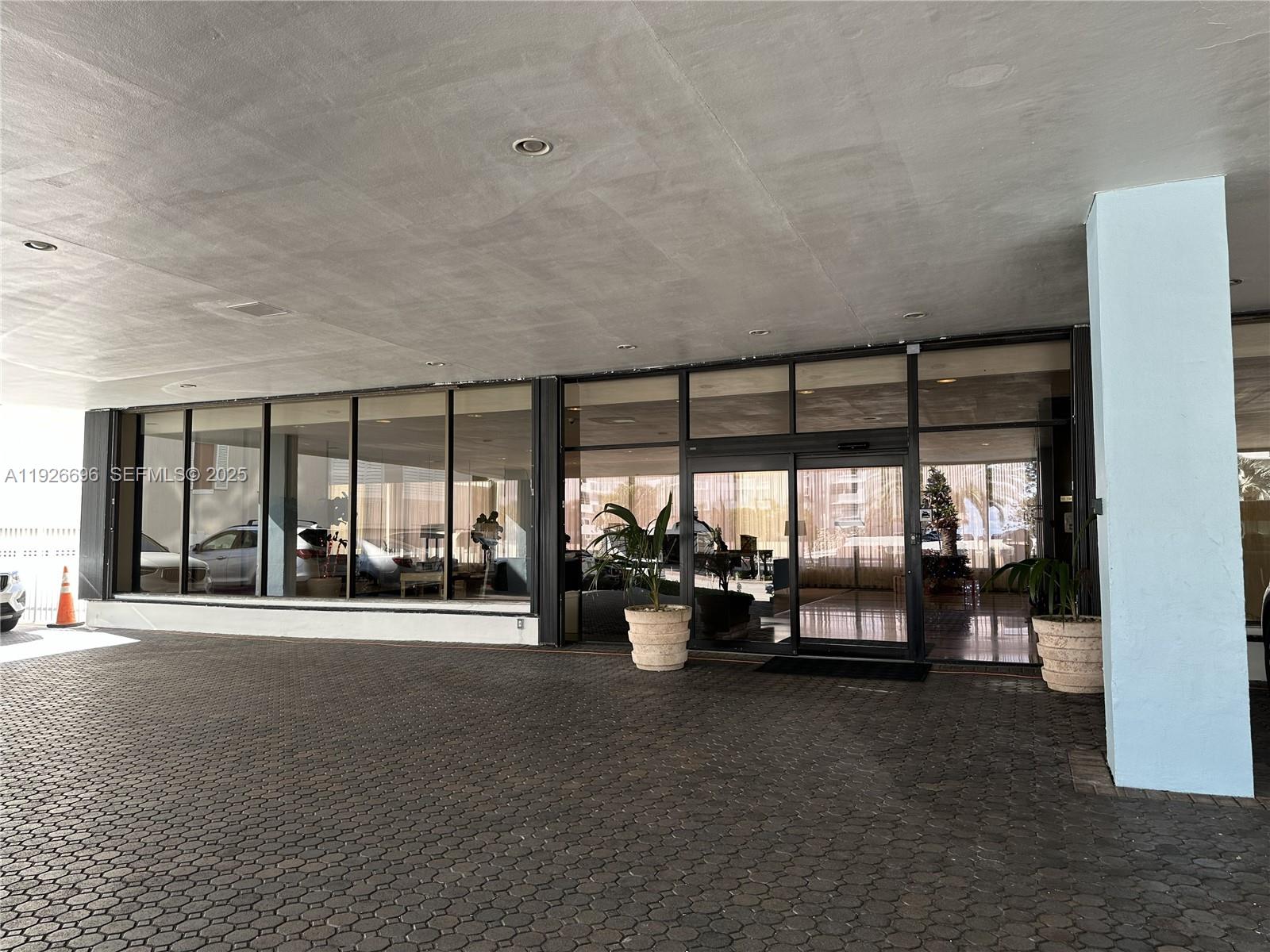 5838 Collins Avenue, Unit 11D Miami Beach, FL 33140 - Photo 21 of 24 a lobby with furniture and floor to ceiling window