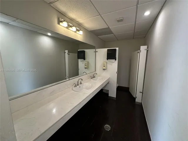 a bathroom with a double vanity sink and mirror