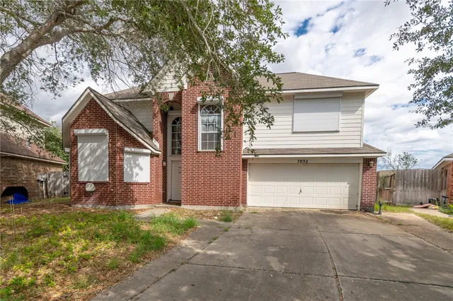 a view of a house with a yard and garage