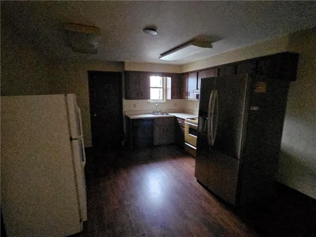 a kitchen with stainless steel appliances wooden cabinets and a refrigerator