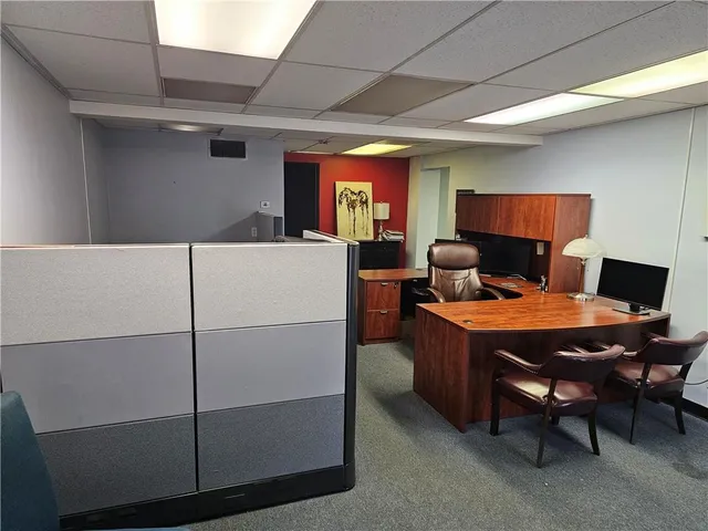 a living room with furniture a chandelier and a table