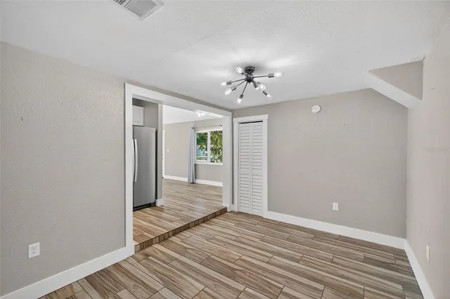 a view of a room with wooden floor and closet