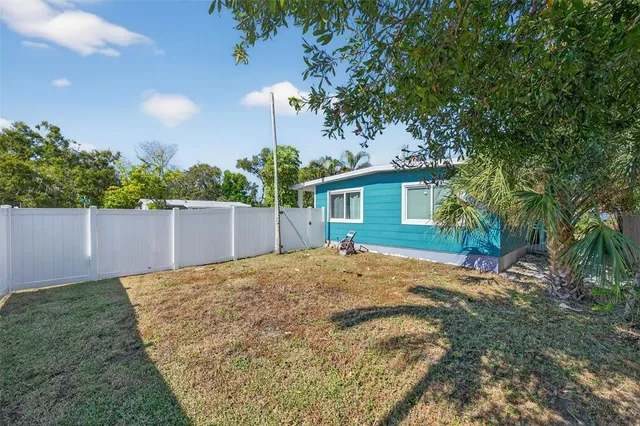 a view of a backyard with a tree
