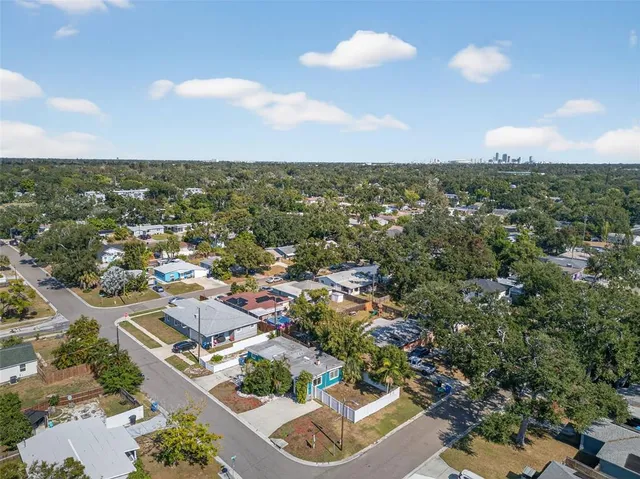 an aerial view of residential houses with outdoor space and street view