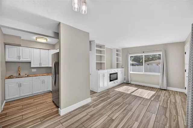 a view of a kitchen with wooden floor and a kitchen