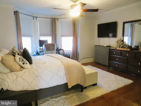 a bedroom with a bed and flat screen tv