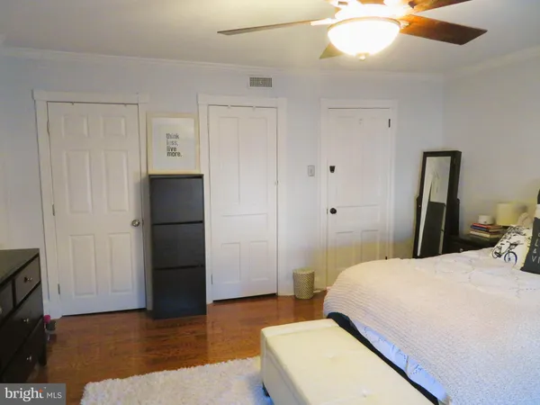 a bedroom with a bed and a mirror