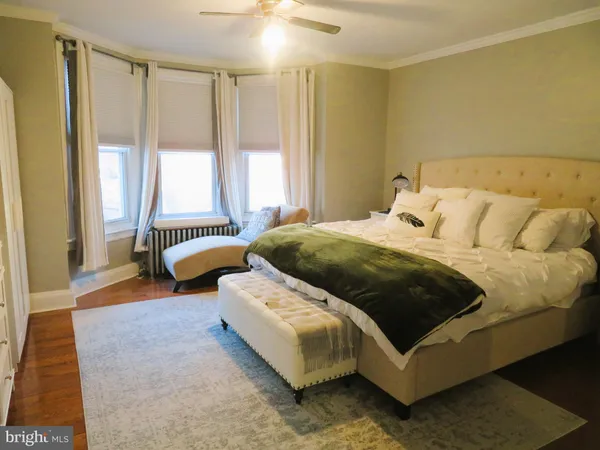 a bedroom with a bed and a couch