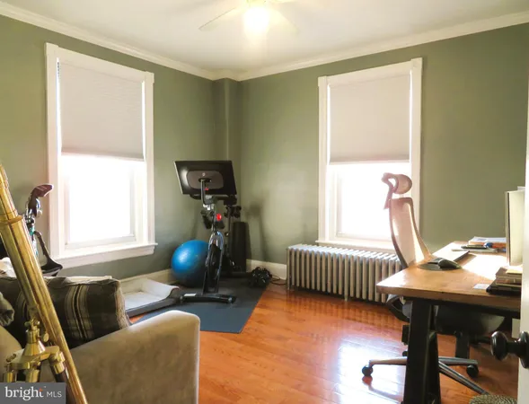 a living room with furniture a window and gym equipment
