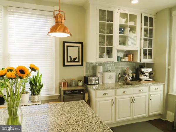 a kitchen with stainless steel appliances kitchen island granite countertop a stove a sink and a cabinets