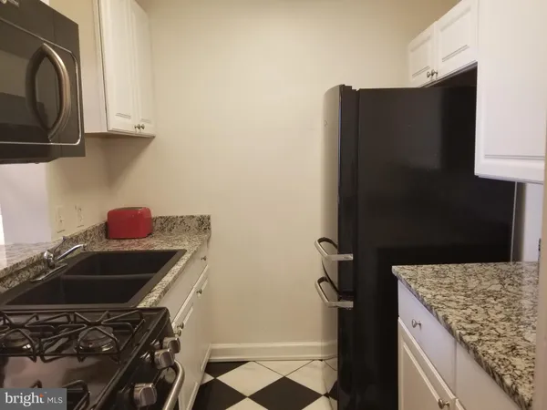 a kitchen that has a sink and a stove