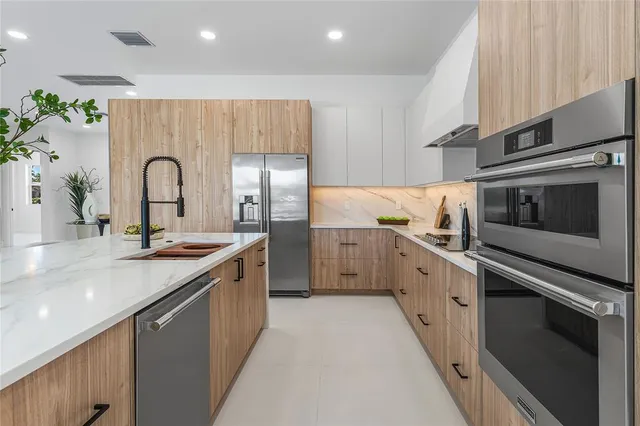 a kitchen with granite countertop white cabinets and white appliances
